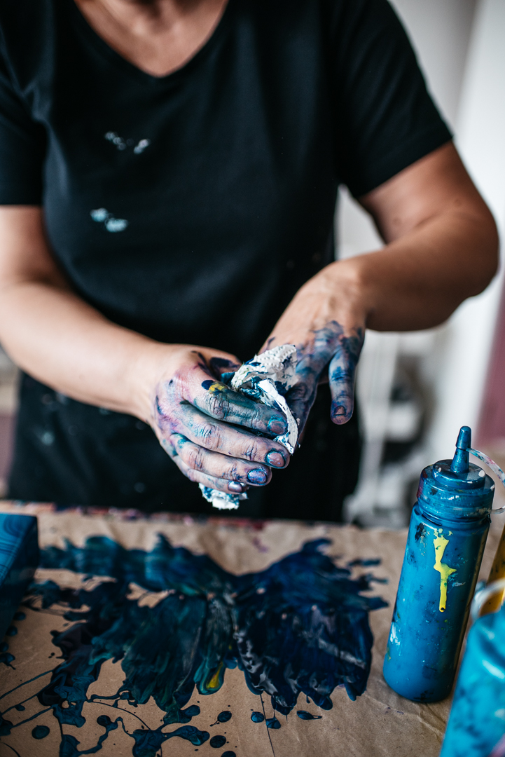 photo of hands in blue paint
